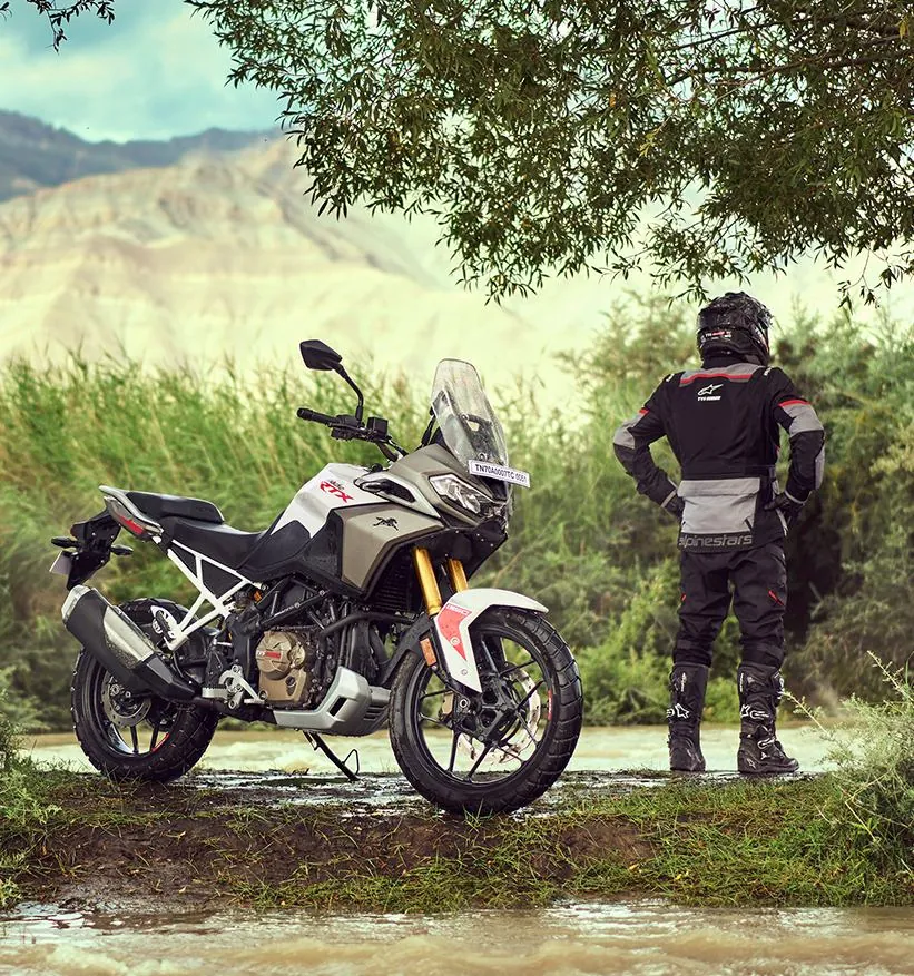 TVS RTX Adventure Motorcycle by Mountain Lake with Rider