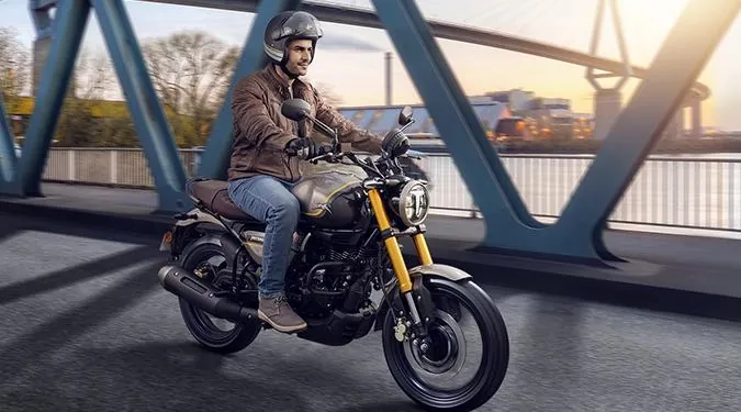 TVS Modern-Retro Motorcycle Cruising across Suspension Bridge
