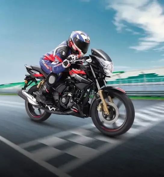 Racer riding a TVS Apache on a race track